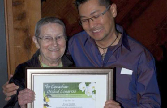 Lynne Cassidy of the Fraser Valley Orchid Society receives COC award